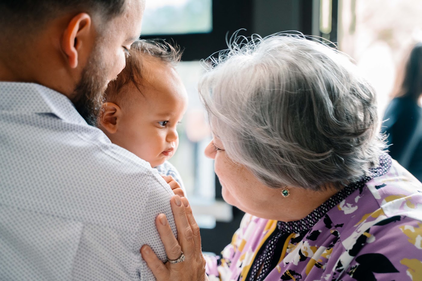 Grandmother greeting a baby at Christ Community Church
